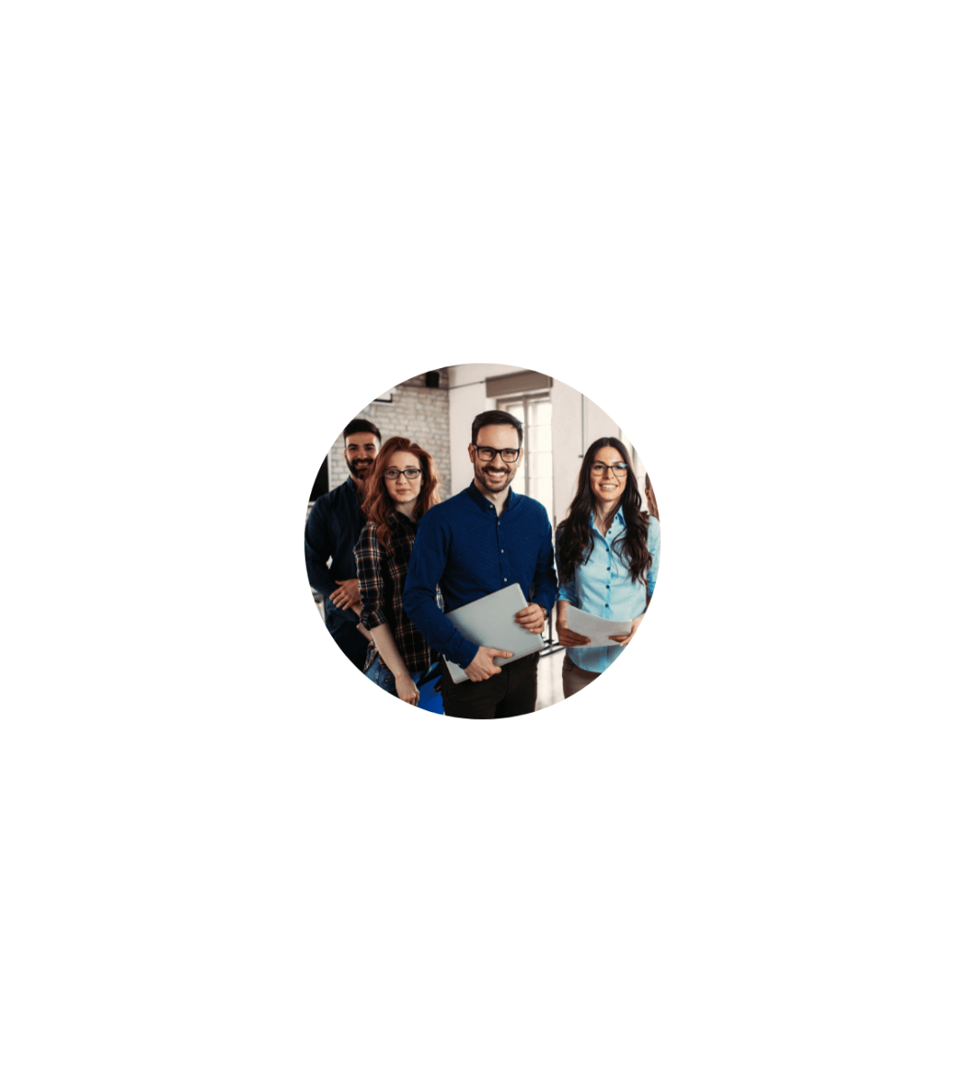 Smiling group of young professionals standing in a row, holding laptops and folders in a modern office space.