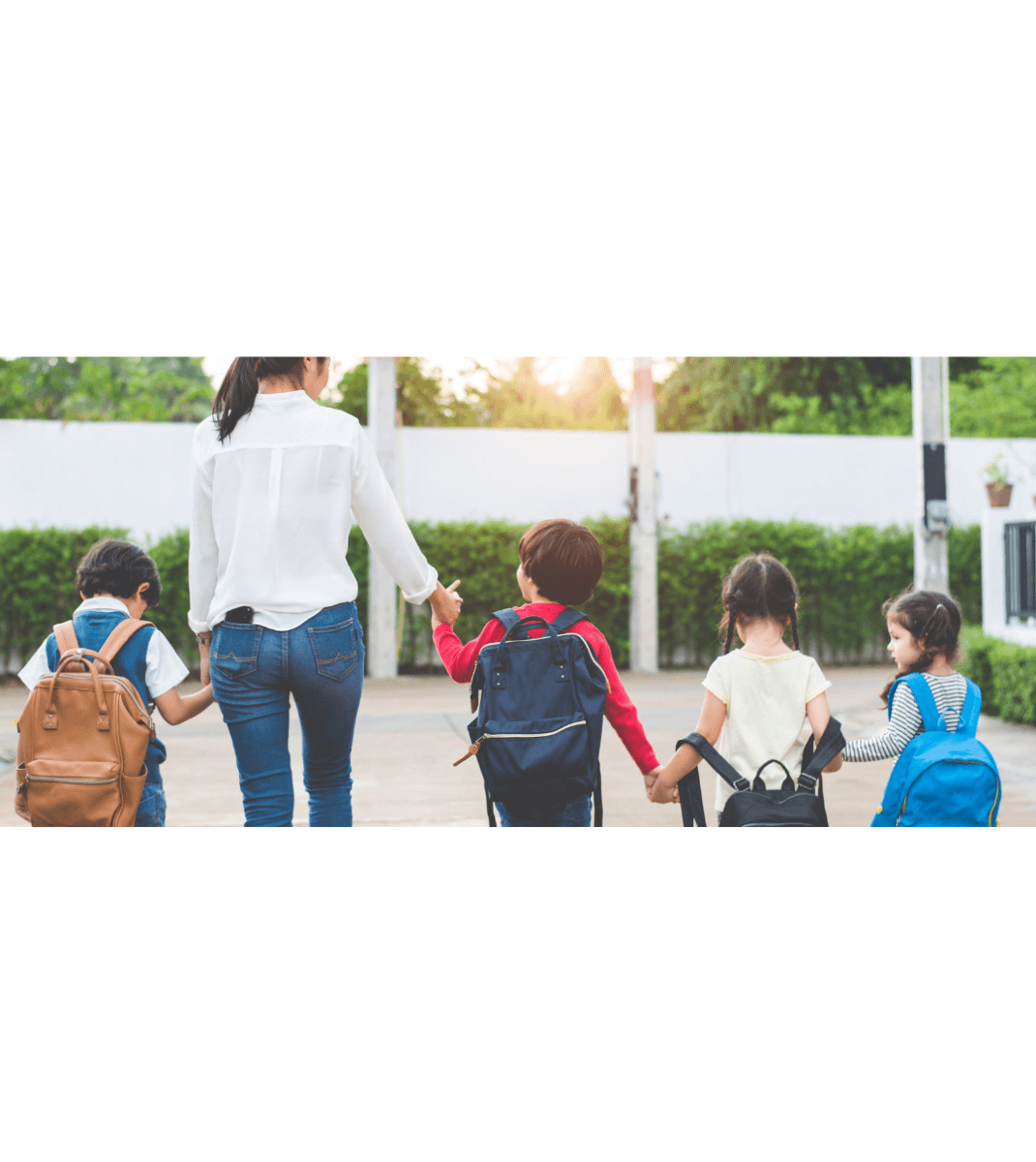 Parent holding hands with 4 children
